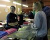 A lady looking at the baby Gerbils for sale.